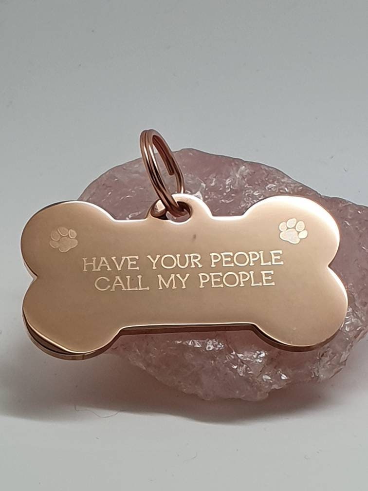 Bone shaped pet ID tag with paw design, 5 colours and 2 sizes to choose from.