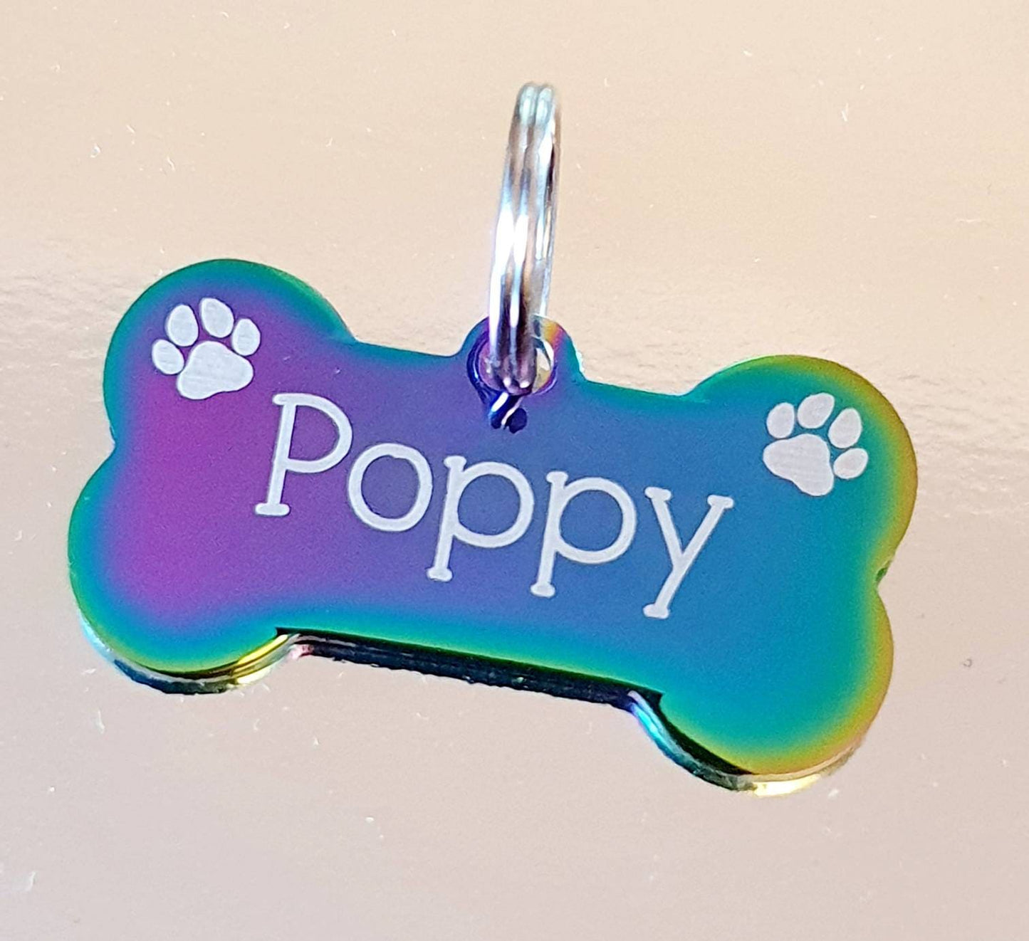 Rainbow coloured Dog ID tags, stainless steel bones. various fonts to choose from. Paw design.