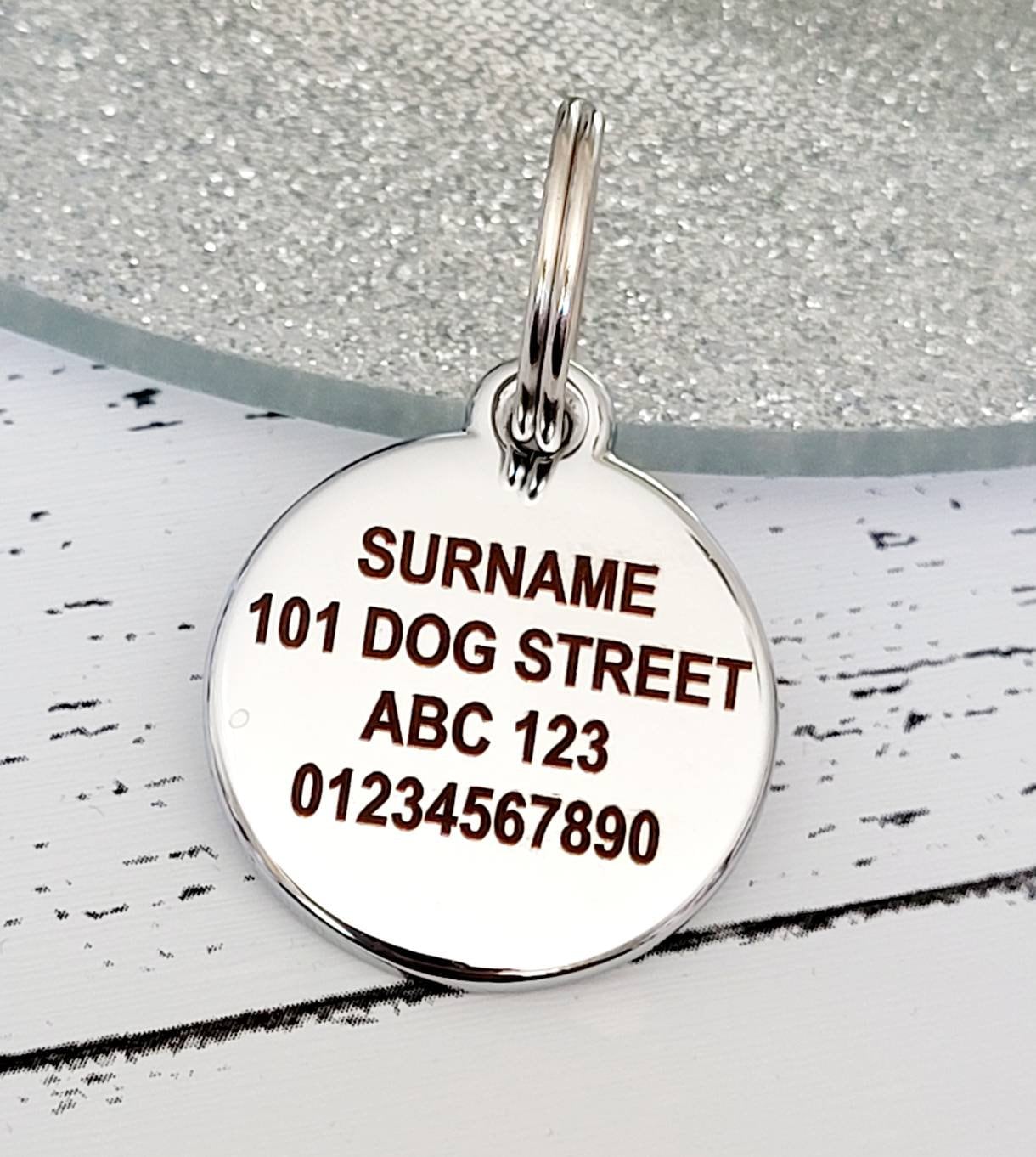 Quality silver alloy with GLITTER coloured paw dog or cat ID tag, laser engraved. Includes a split ring.