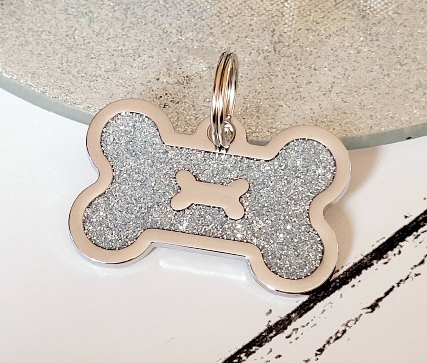 Quality coloured silver sparkly bone dog ID tag, laser engraved.