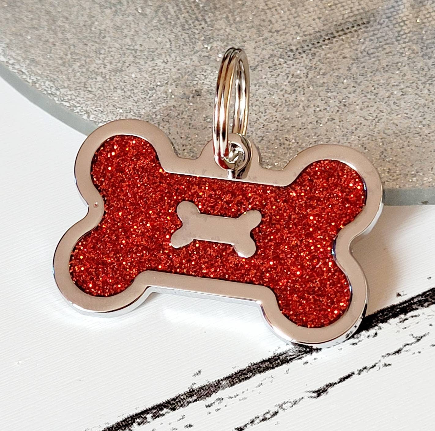 Quality coloured red sparkly bone dog ID tag, laser engraved.