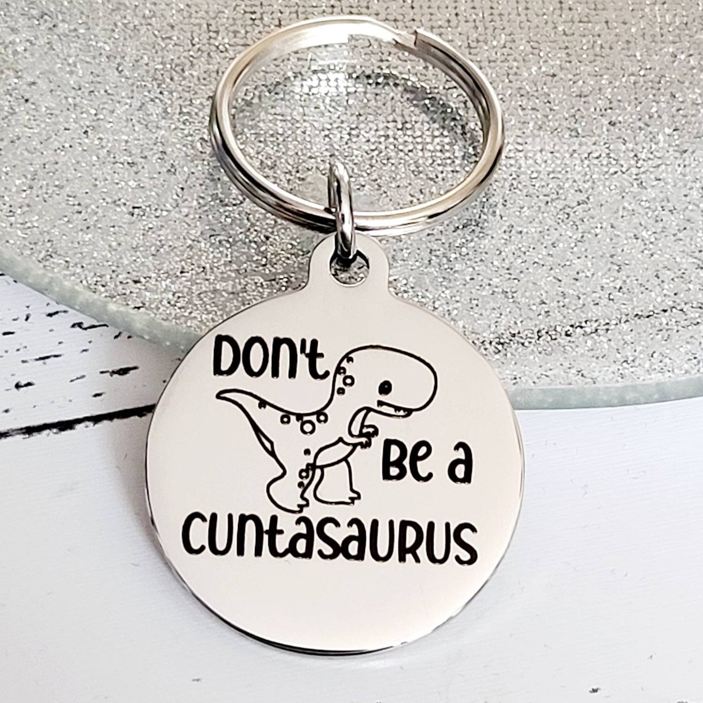 Don't be a Cuntasaurus. Profanity keyring.