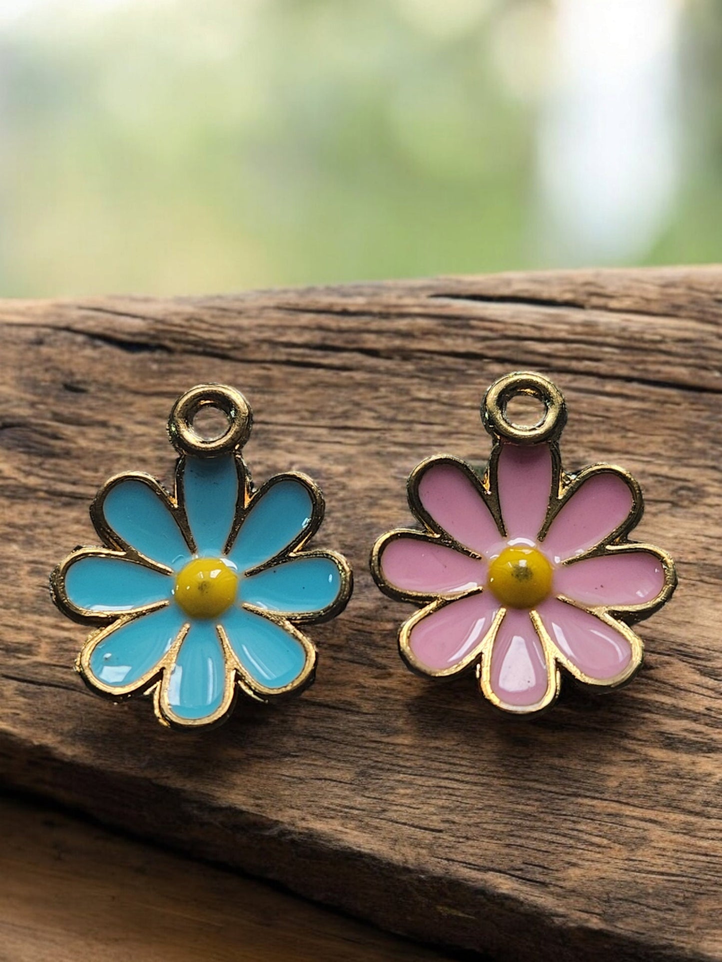 Gold pet ID tag with pink or blue daisy charm.