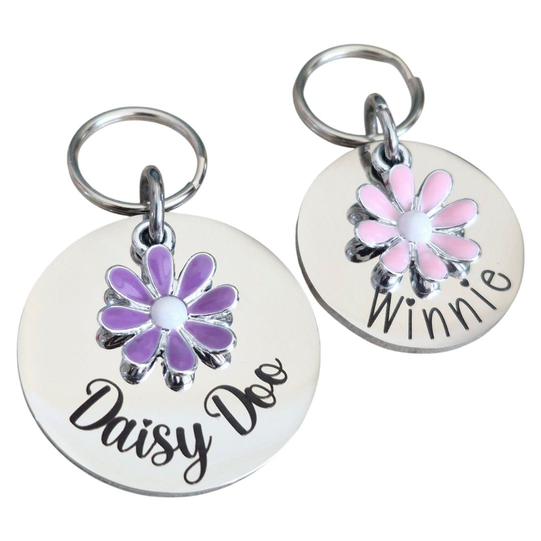 Silver pet ID tag with pink or lilac daisy charm. 25 or 30mm stainless steel.