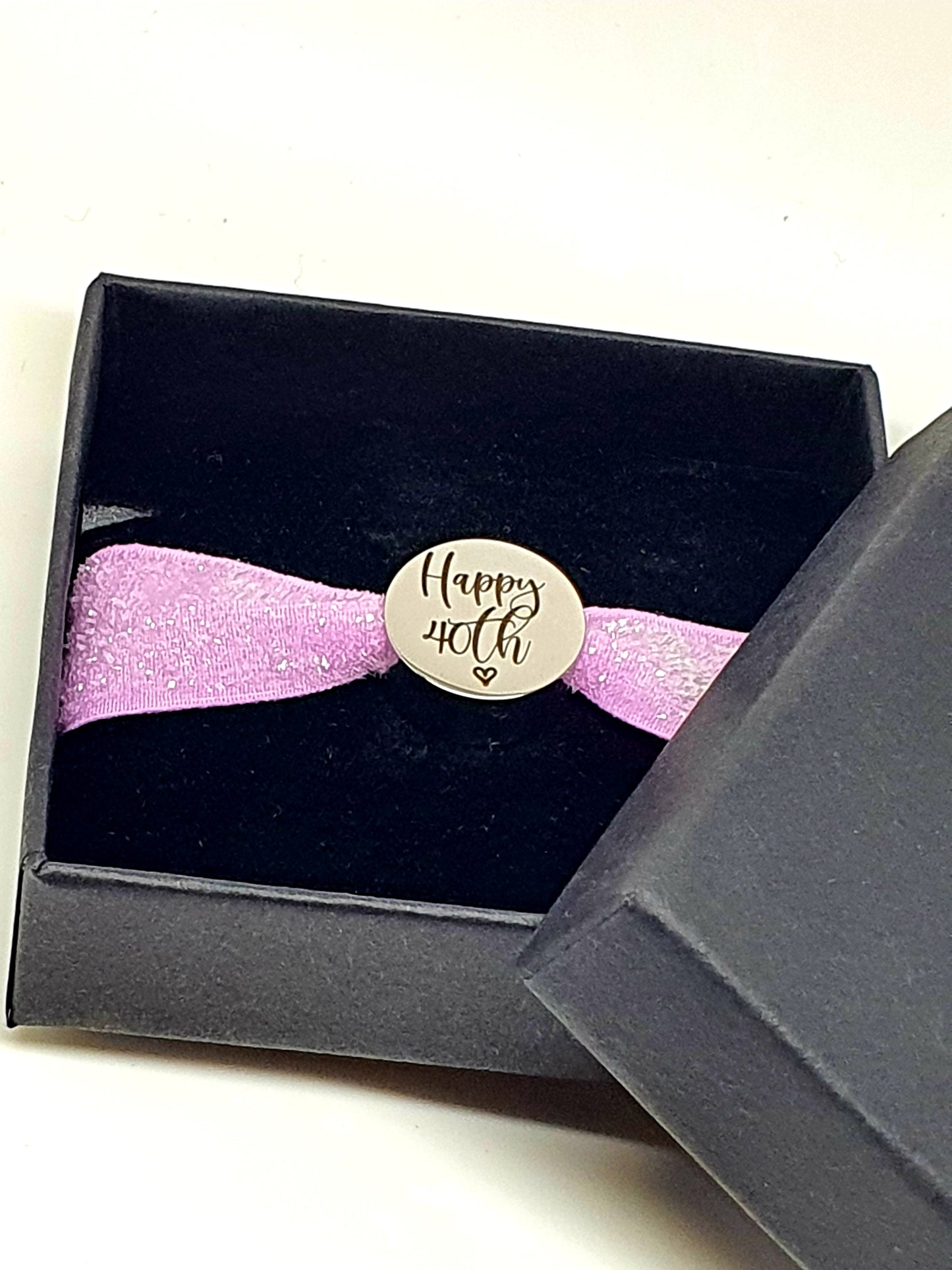 Stainless steel charm with elasticated band