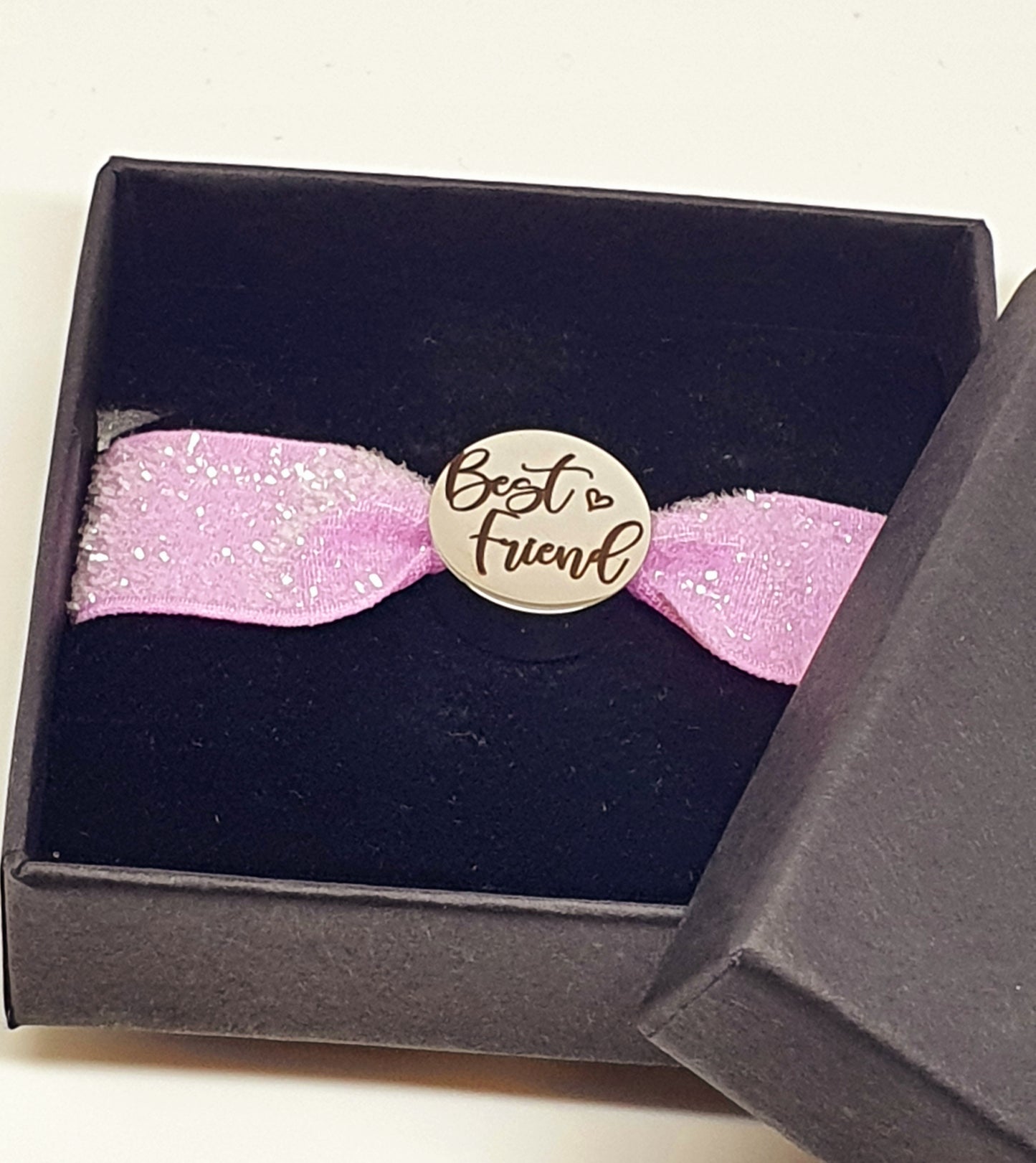 Stainless steel charm with elasticated band