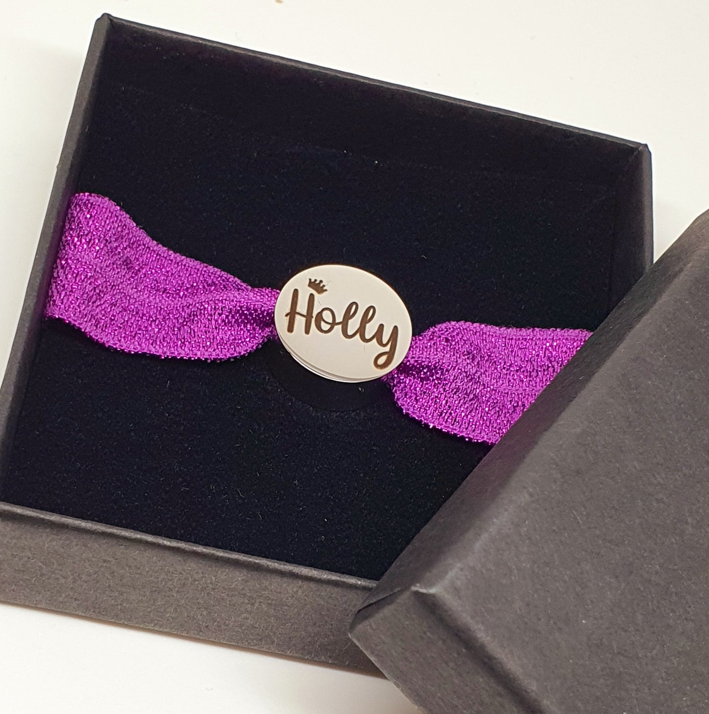 Stainless steel charm with elasticated band