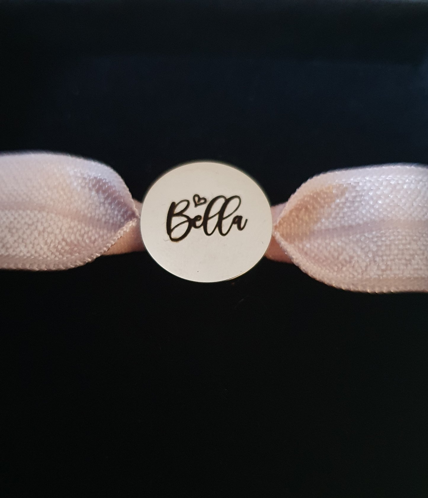 Stainless steel charm with elasticated band