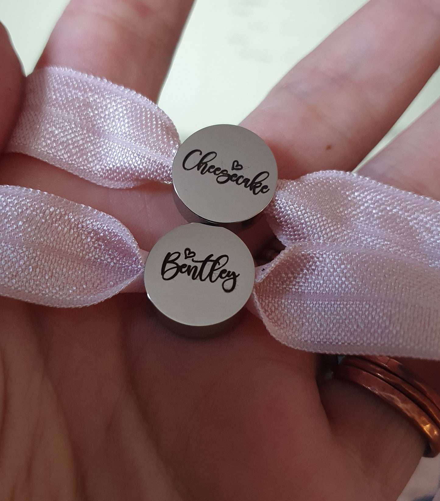 Stainless steel charm with elasticated band