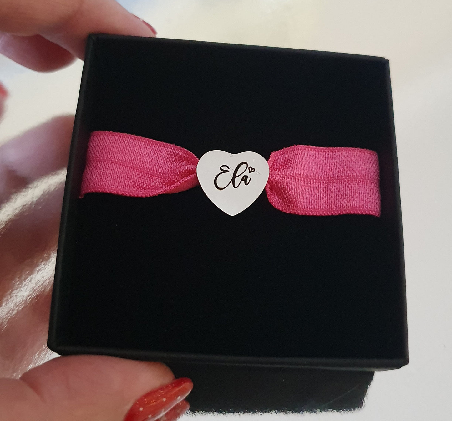 Stainless steel charm with elasticated band