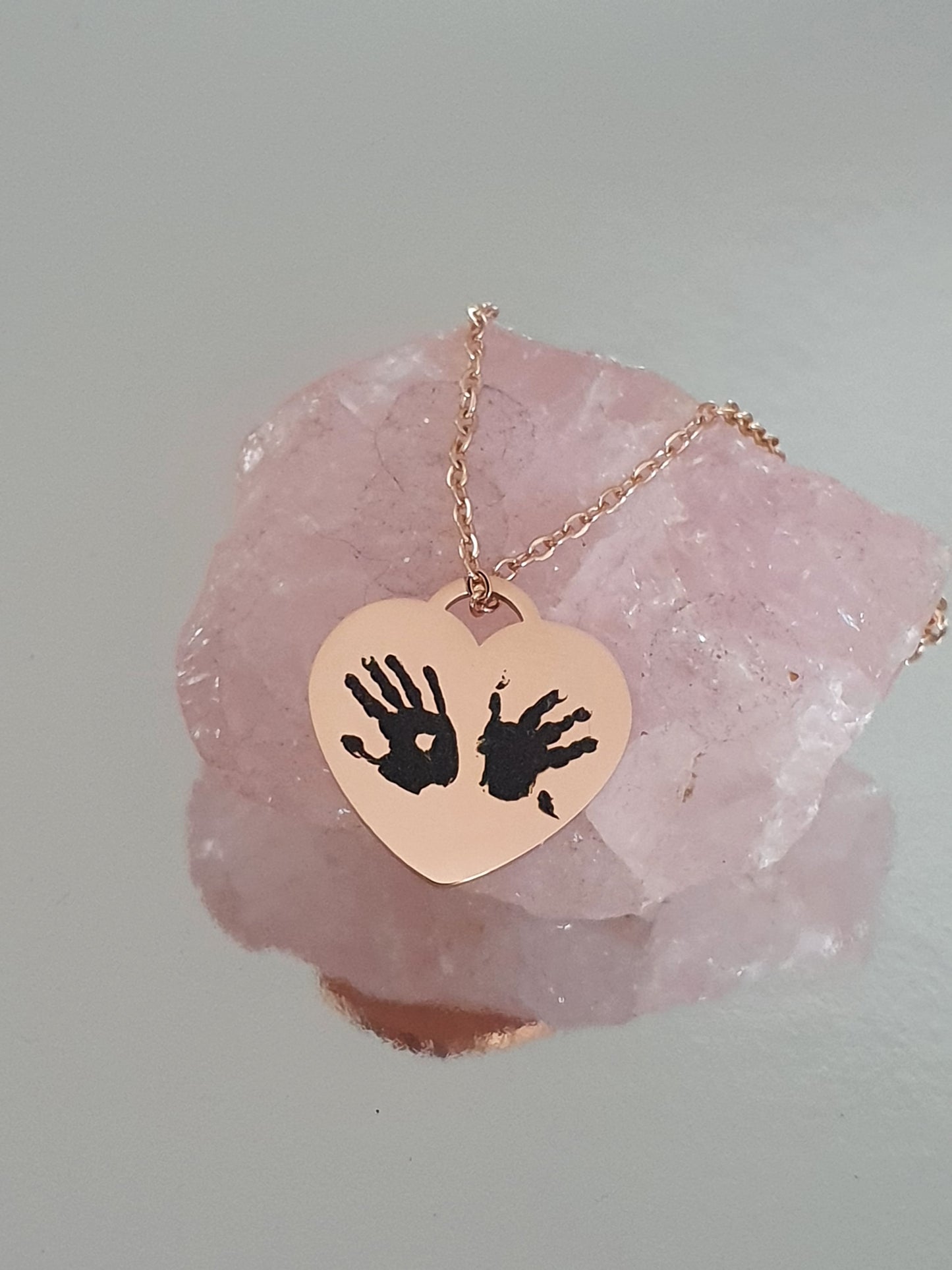 Stainless steel handprints necklace.