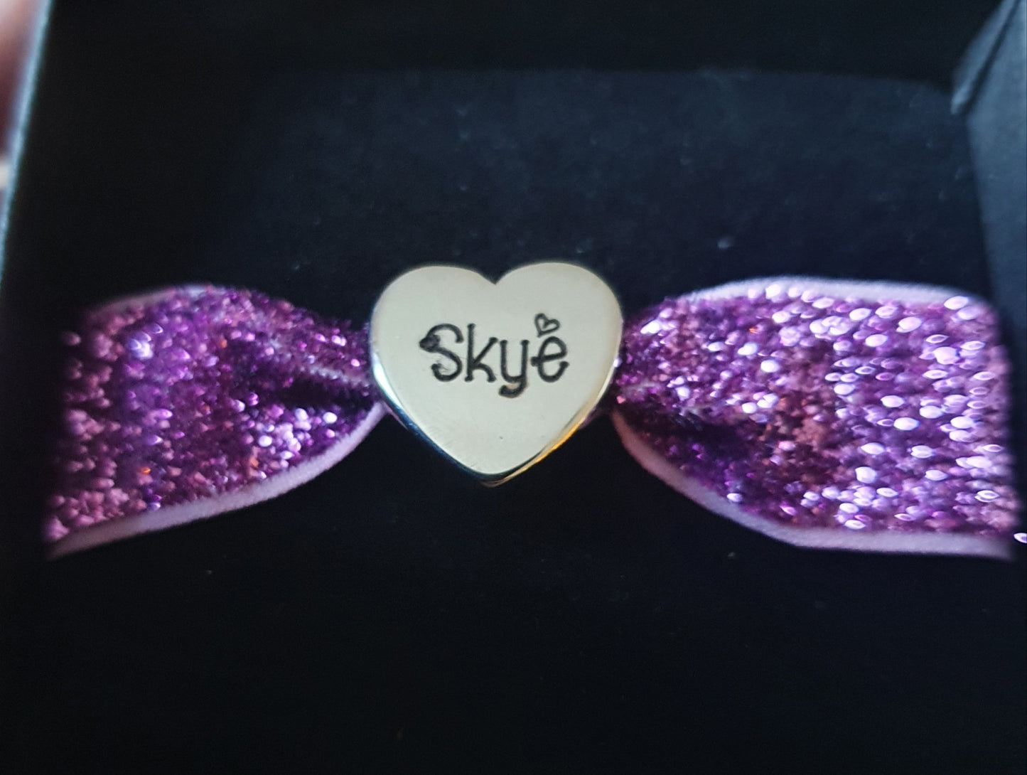 Stainless steel charm with elasticated band