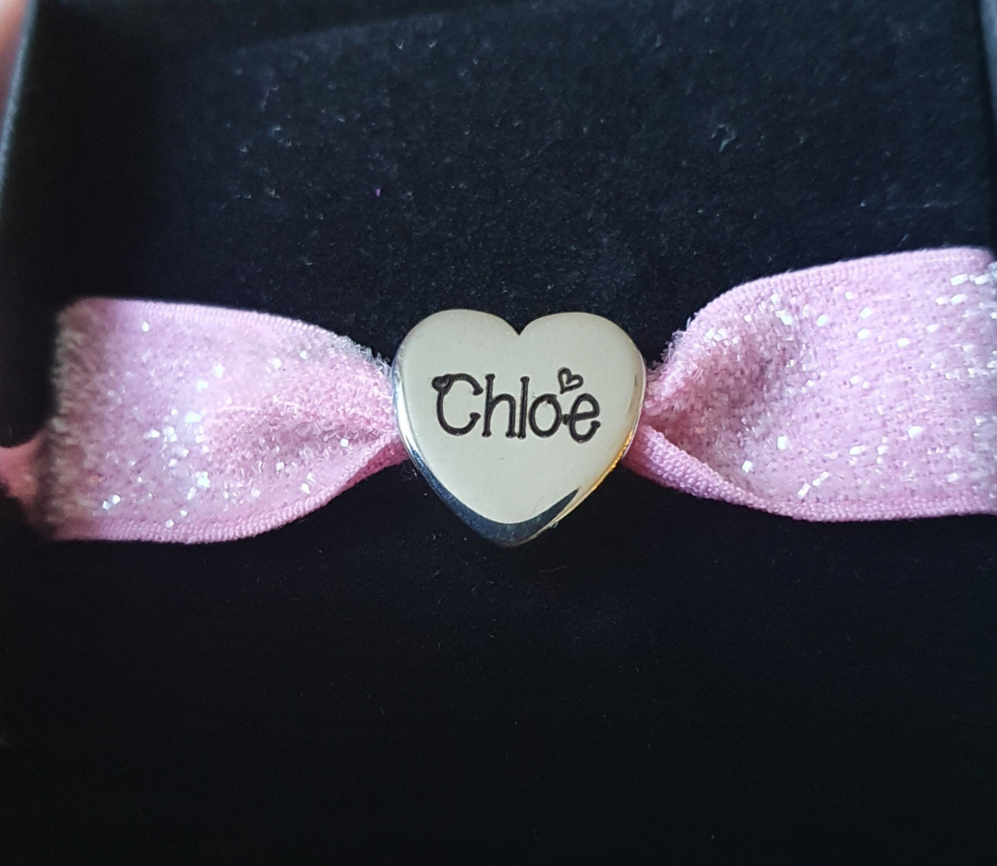 Stainless steel charm with elasticated band