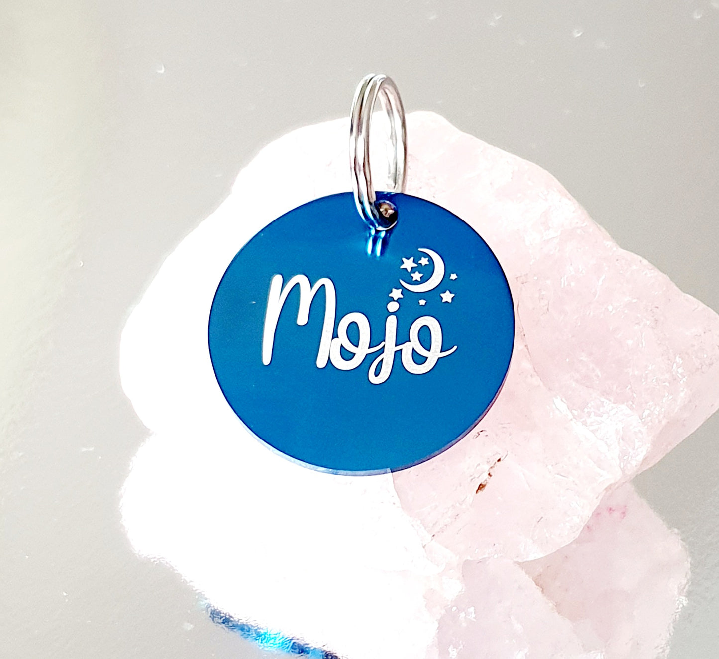 Stainless steel disk with moon and star design.